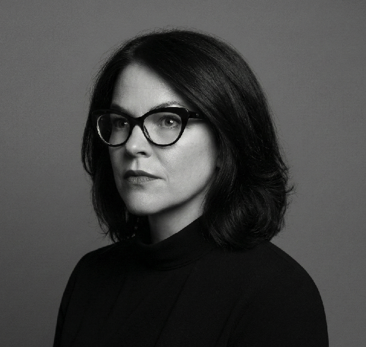 Black and White photo of Yvonne wearing glasses and looking to the left.